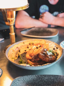 A Pixar-themed restaurant bar at Disney's California Adventure at Disneyland resort! Everything you need to know about the food, drinks, and Pixar details at Lamplight Lounge #disneyland #dlr #dca #disneycaliforniaadventure #disney Disney food | Disney restaurants | disneyland food | Lamplight lounge | best dinner at disneyland | best lunch at disneyland | bars at disneyland | pixar restaurant at disneyland | pixar bar at disneyland | disney eats | disney dining | disney food tips 