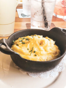 Homecomin' Kitchen at Disney Springs is the best restaurant at Disney World. With the best mac and cheese at Disney, the perfect water view, and a selection of resort cocktails and moonshine, this place cannot be beat. #disneyworld #disneysprings #disneyfood Disney food | Disney restaurants | Disney eats | Disney dining | Disney world restaurants | Disney springs restaurants | Disney springs food | Disney springs dining | Disney world food | Disney world dining | Homecoming Kitchen | Art Smith